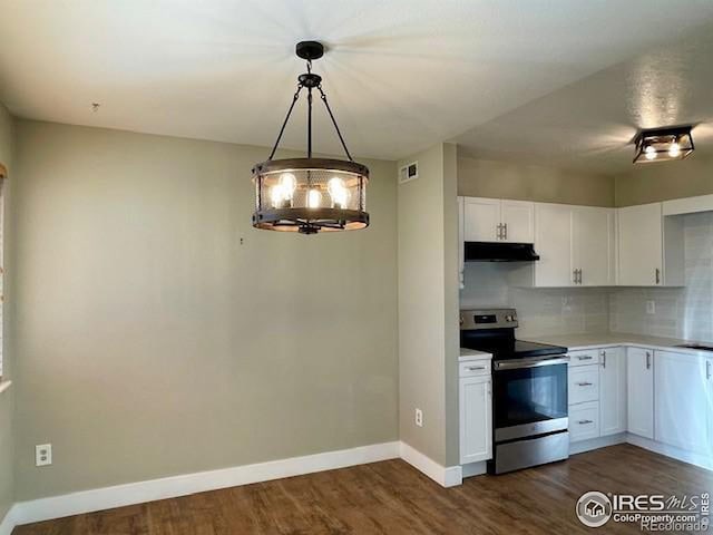 kitchen with decorative backsplash, dark hardwood / wood-style flooring, decorative light fixtures, white cabinets, and stainless steel electric range