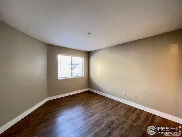 empty room featuring dark wood-type flooring