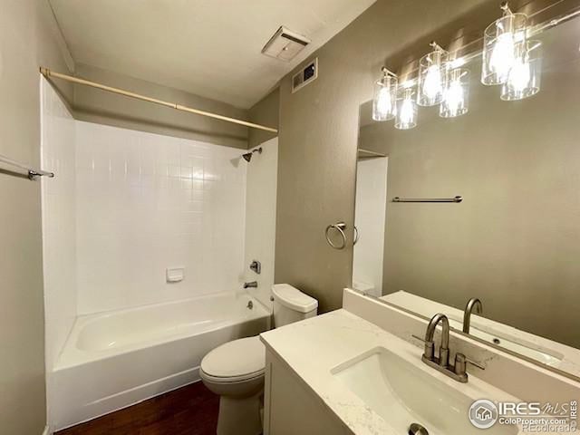 full bathroom featuring hardwood / wood-style flooring, vanity, toilet, and bathing tub / shower combination