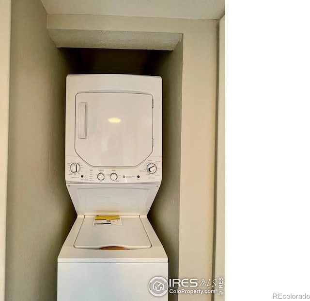 washroom with stacked washer / drying machine