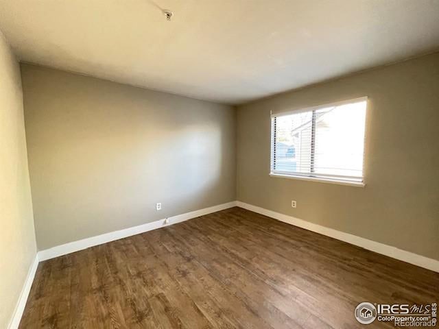 unfurnished room featuring dark hardwood / wood-style floors