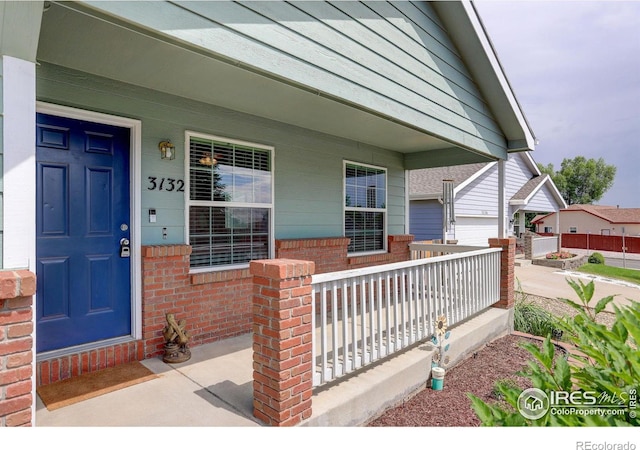 view of exterior entry with a porch