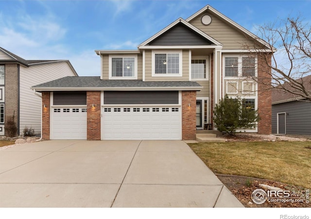 view of front of home featuring a front lawn and a garage