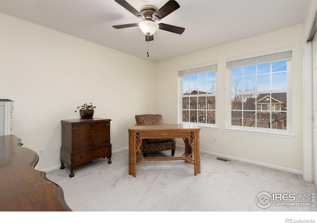 carpeted home office with ceiling fan