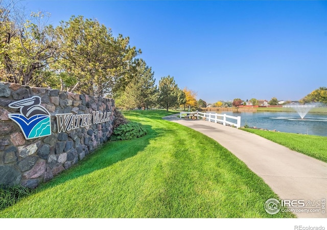 view of home's community featuring a yard and a water view