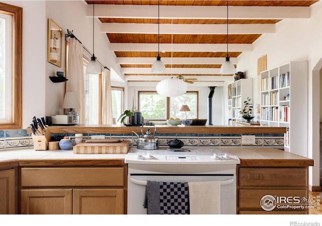 kitchen with pendant lighting, beam ceiling, wood ceiling, and white stove