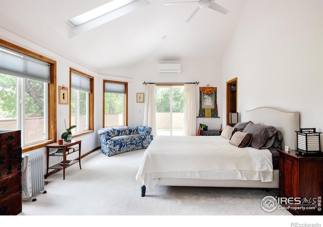 carpeted bedroom featuring a wall mounted air conditioner, ceiling fan, and vaulted ceiling with skylight