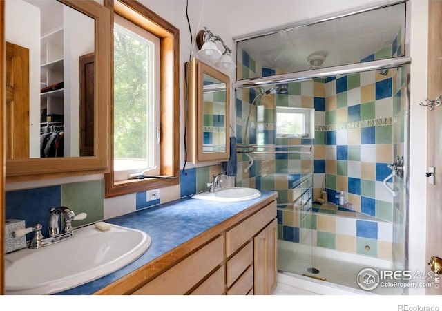 bathroom featuring vanity and a shower with door