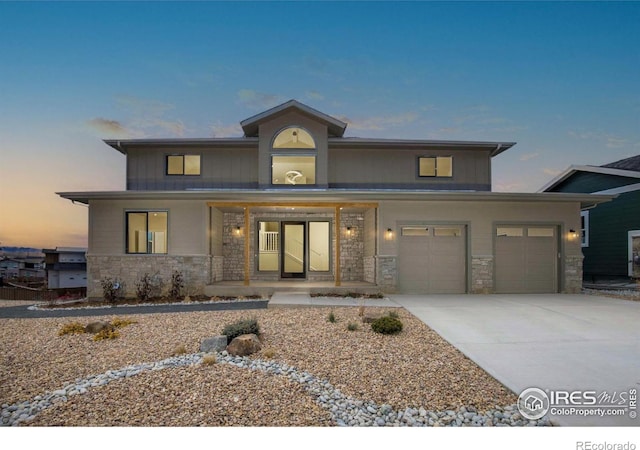 view of front of home featuring a porch and a garage