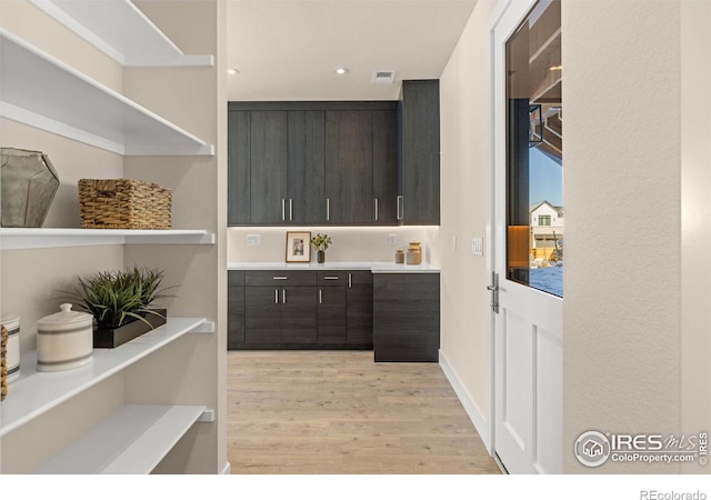 interior space with dark brown cabinets and light wood-type flooring