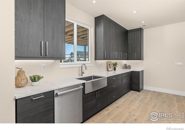 kitchen with dishwasher, light hardwood / wood-style flooring, and sink