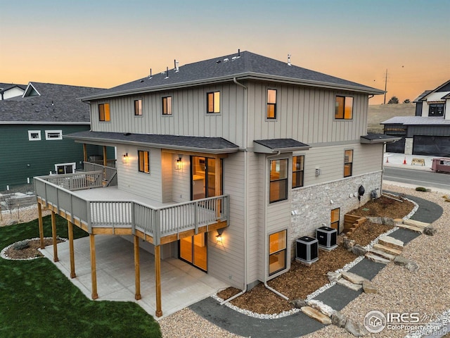 view of front of property featuring cooling unit, a patio, and a deck