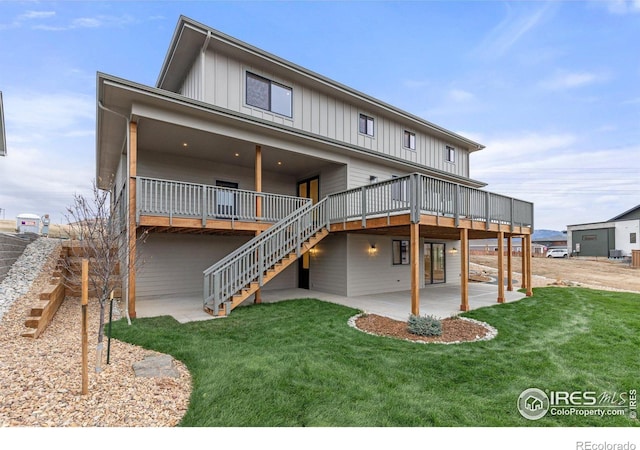 rear view of house with a lawn, a patio area, and a deck