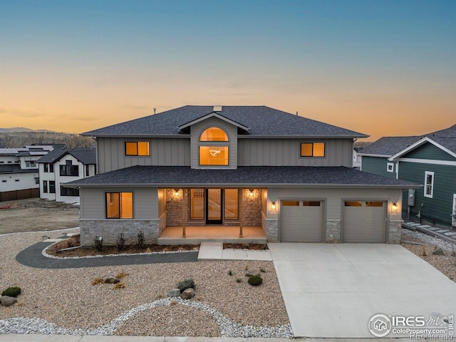 view of front of home featuring covered porch and a garage