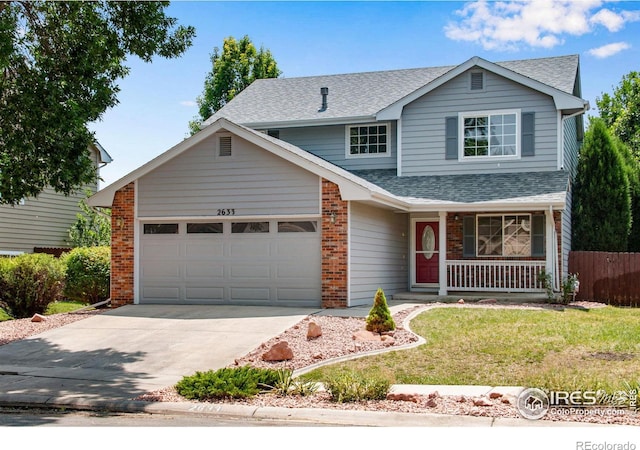 view of front of property featuring covered porch, a front yard, and a garage