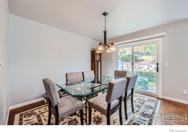 dining area featuring hardwood / wood-style floors and a chandelier