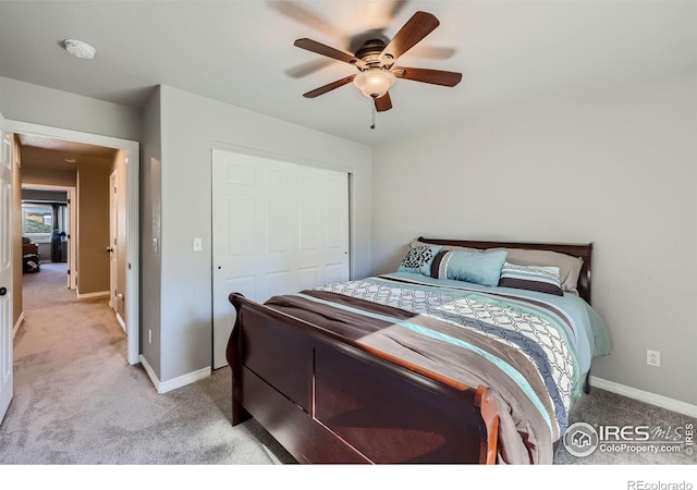 bedroom with ceiling fan, a closet, and light colored carpet