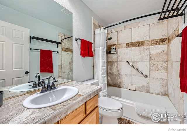 full bathroom featuring vanity, shower / bath combo, and toilet