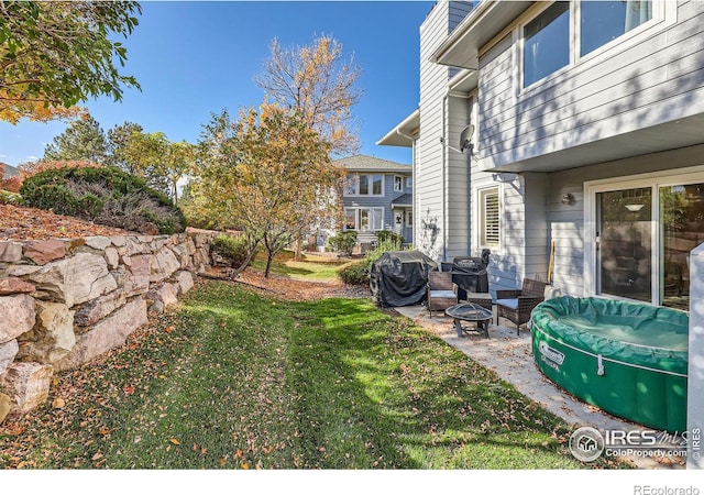 view of yard with a fire pit and a patio area