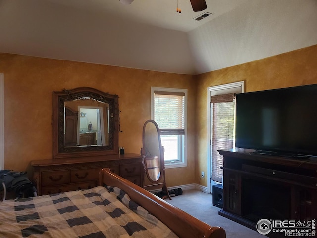 bedroom featuring ceiling fan, light colored carpet, and lofted ceiling