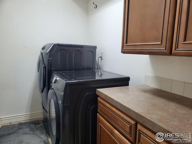 laundry room with separate washer and dryer and cabinets