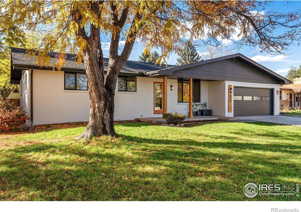 single story home with a front lawn, a porch, and a garage