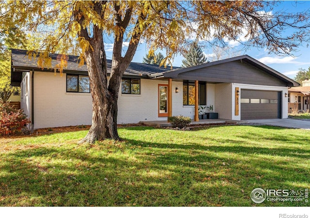 single story home with a front lawn, a porch, and a garage