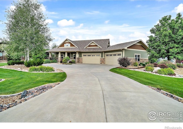 craftsman-style house featuring a garage and a front yard