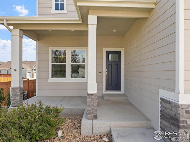 view of exterior entry with a porch