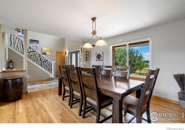 dining area featuring a chandelier and light hardwood / wood-style flooring