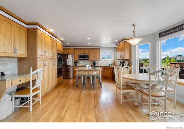 dining space with sink and light hardwood / wood-style flooring