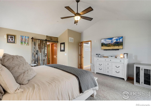 carpeted bedroom featuring a barn door, vaulted ceiling, and ceiling fan