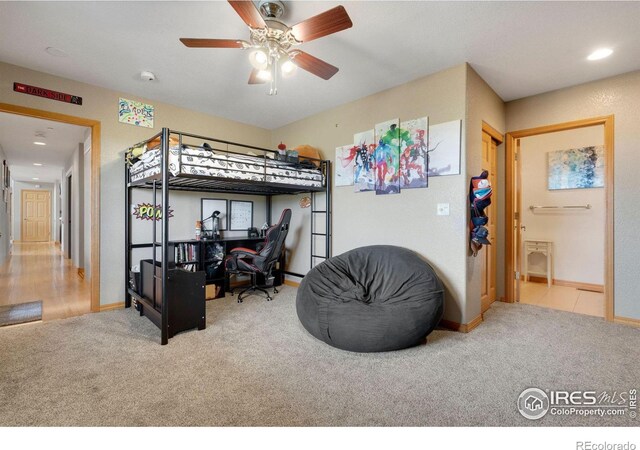 carpeted bedroom with ceiling fan and ensuite bathroom