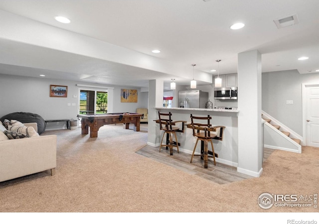 recreation room with light colored carpet and billiards