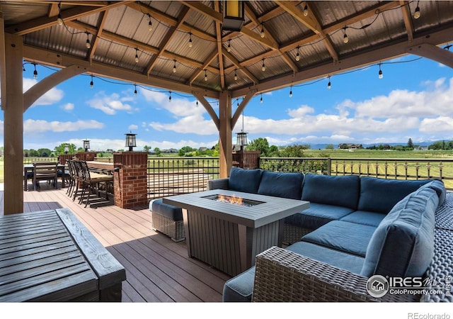 deck with a gazebo and an outdoor living space with a fire pit