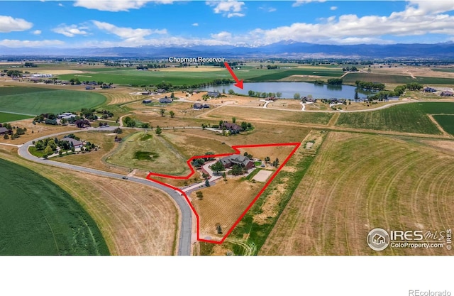 drone / aerial view featuring a rural view and a water and mountain view