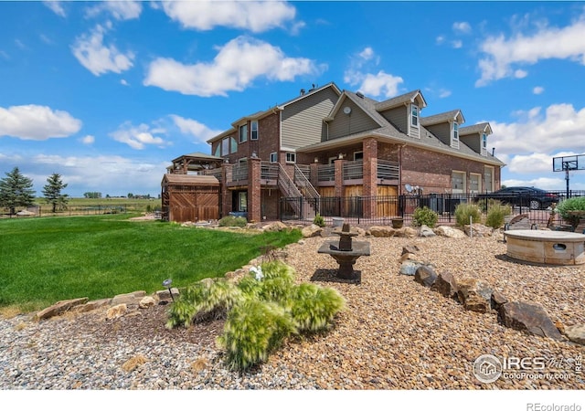 rear view of property featuring a yard and a wooden deck