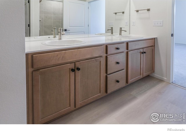 bathroom with hardwood / wood-style flooring and vanity