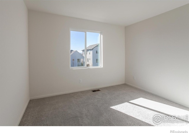 unfurnished room featuring carpet