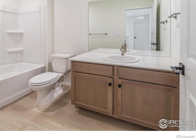 full bathroom featuring hardwood / wood-style flooring, vanity, toilet, and bathtub / shower combination