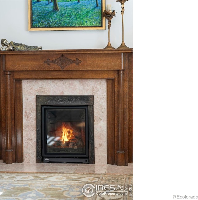 room details featuring a tiled fireplace