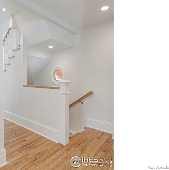 stairs with hardwood / wood-style floors