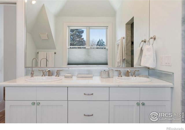 bathroom featuring vanity and vaulted ceiling