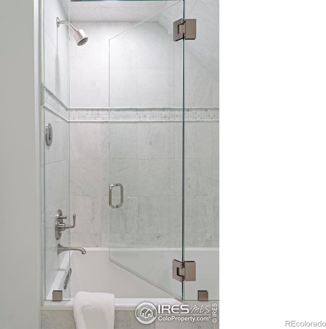 bathroom featuring combined bath / shower with glass door