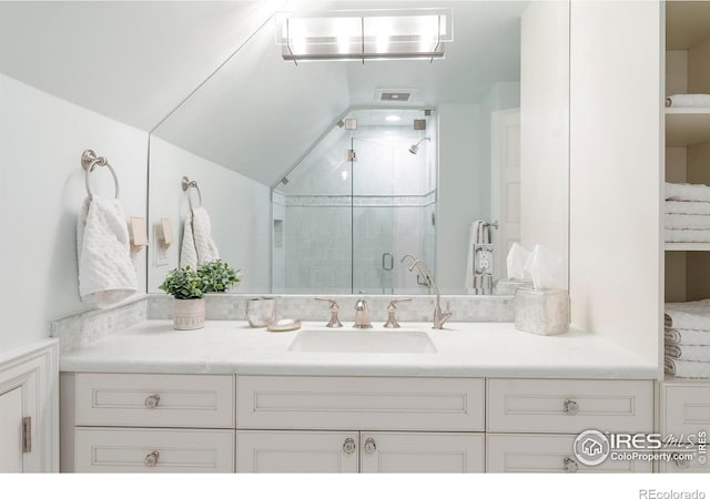 bathroom with vanity and a shower with shower door