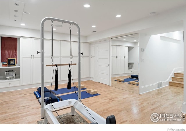 workout room featuring light wood-type flooring