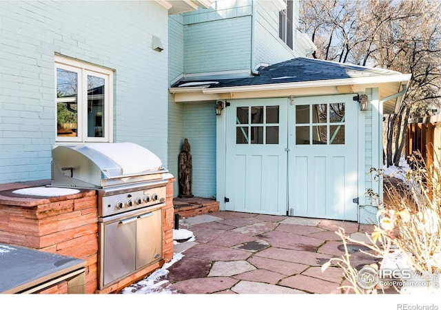 view of patio / terrace featuring grilling area and an outdoor kitchen