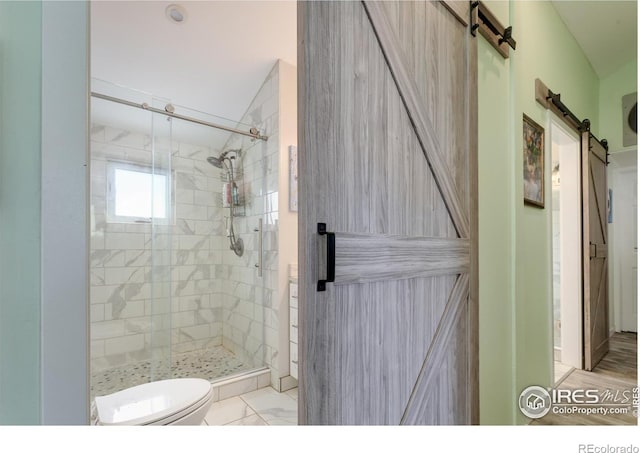 bathroom featuring toilet and an enclosed shower