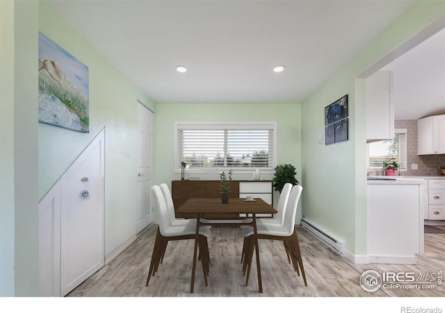 dining room featuring light wood-type flooring and a baseboard radiator