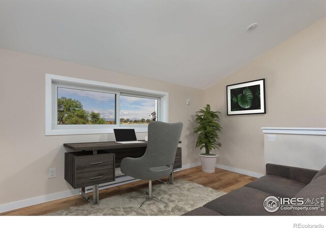 office area featuring light hardwood / wood-style flooring and lofted ceiling